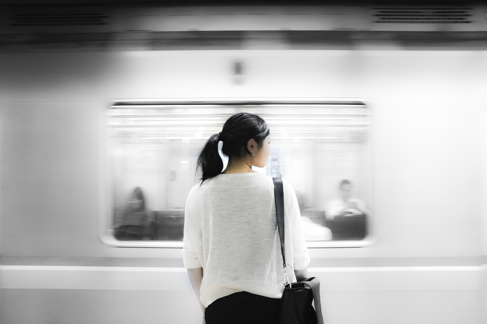 A commuter waiting for a train alone